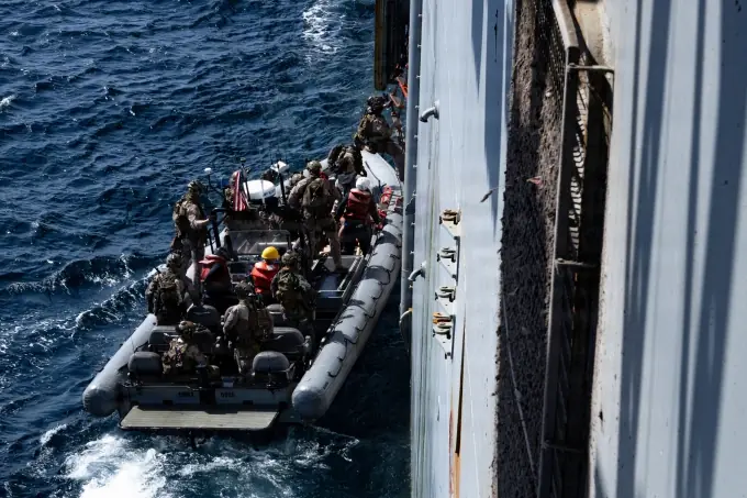 US soldiers disembark and search a cargo ship near Iran