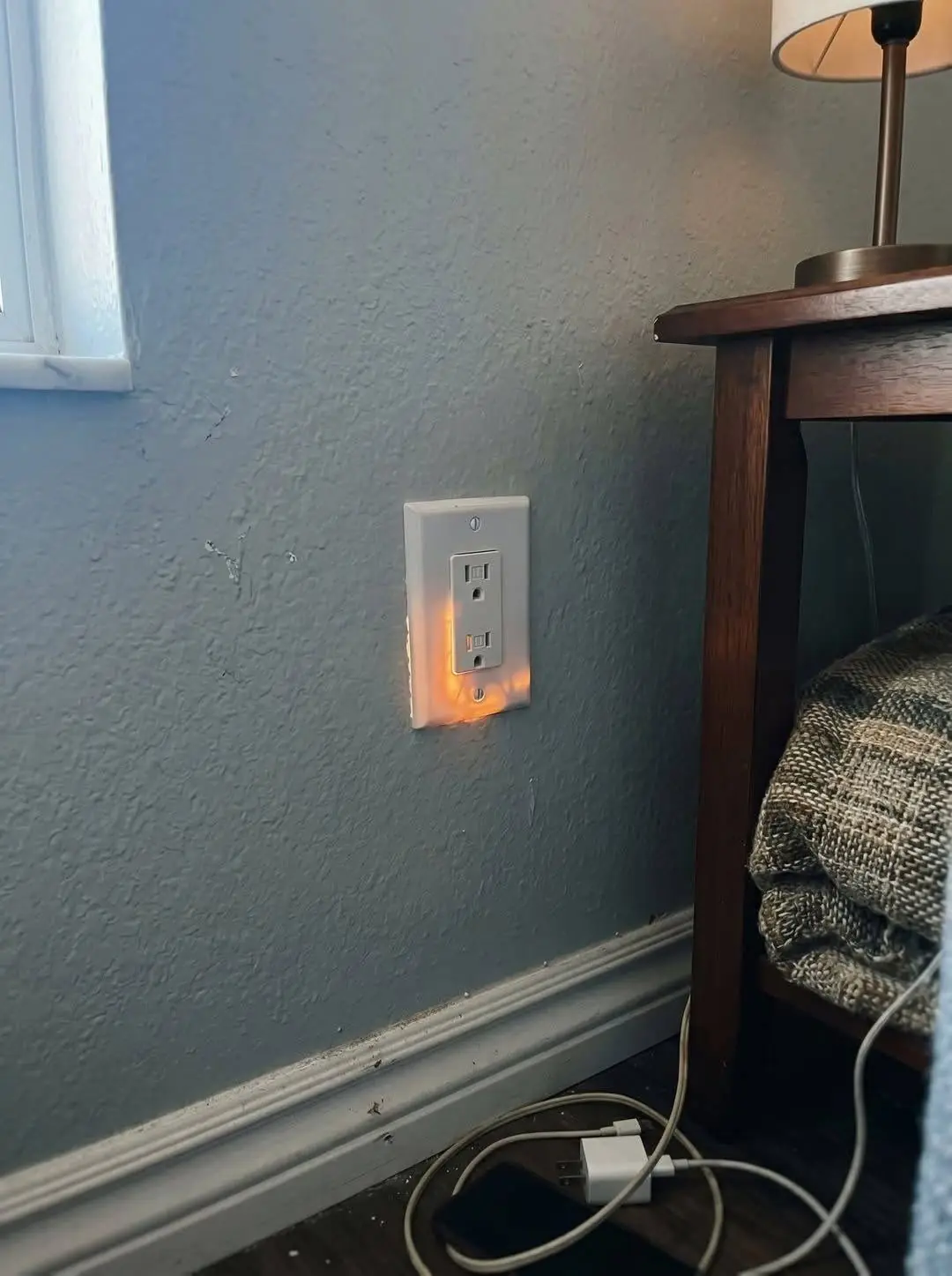 I noticed a light behind my outlet out of nowhere. Is this something to be concerned about?